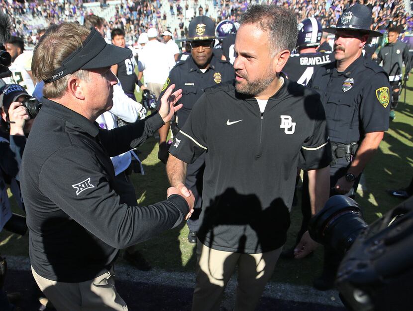 TCU head coach Gary Patterson shakes hands with Baylor head coach Matt Rhule after the...