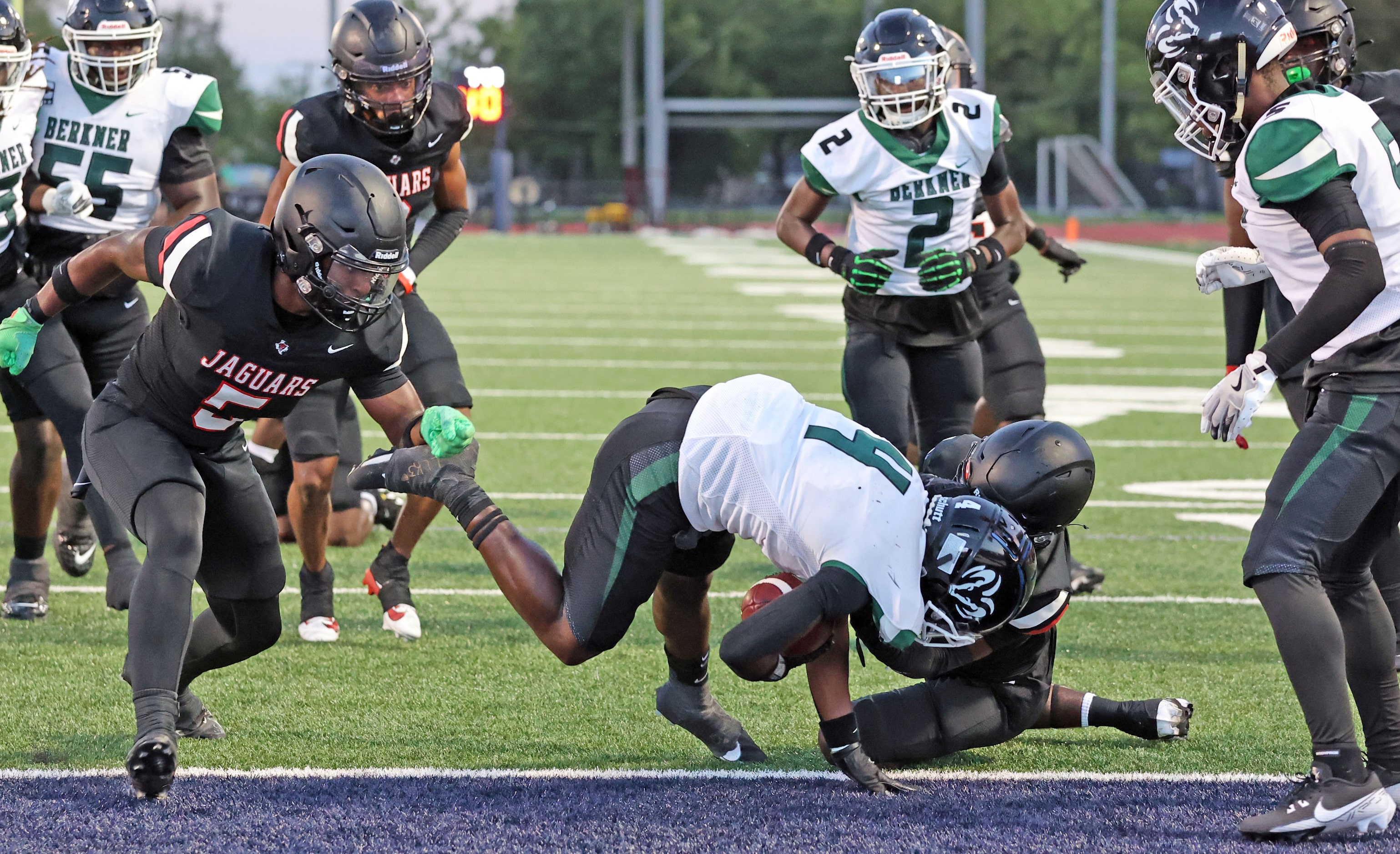 Richardson Berkner high’s Jaelyn Thomas (4) tumbles over a Mesquite Horn high defender and...