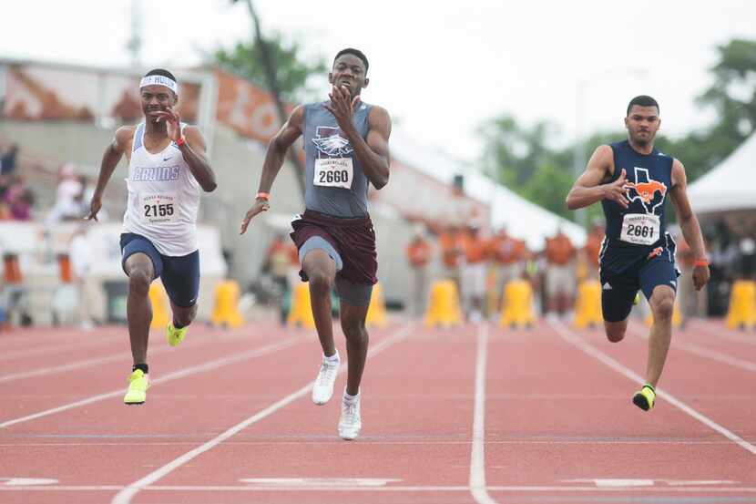 Rowlett's Joseph Sheffield, center, takes first in the boys 100-meter dash with a time of...