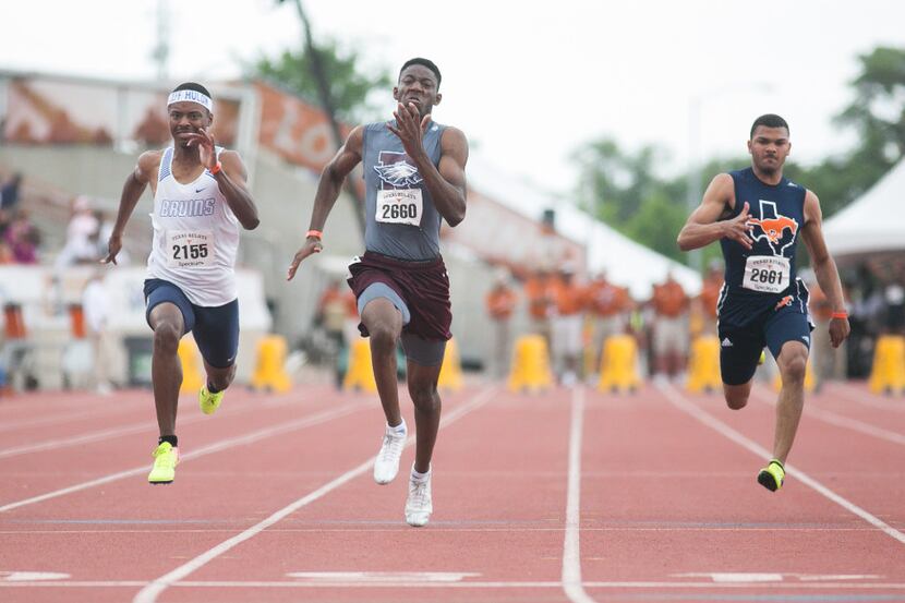 Rowlett's Joseph Sheffield, center, takes first in the boys 100-meter dash with a time of...