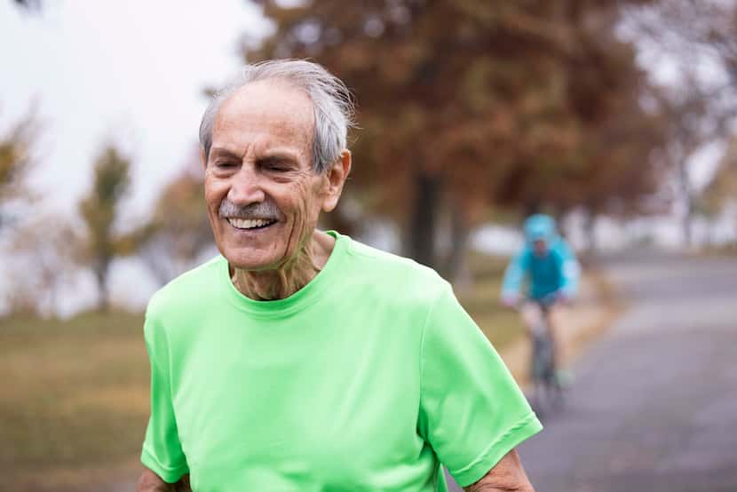 James Thruston, 84, smiles while running during a photoshoot following his usual morning run...