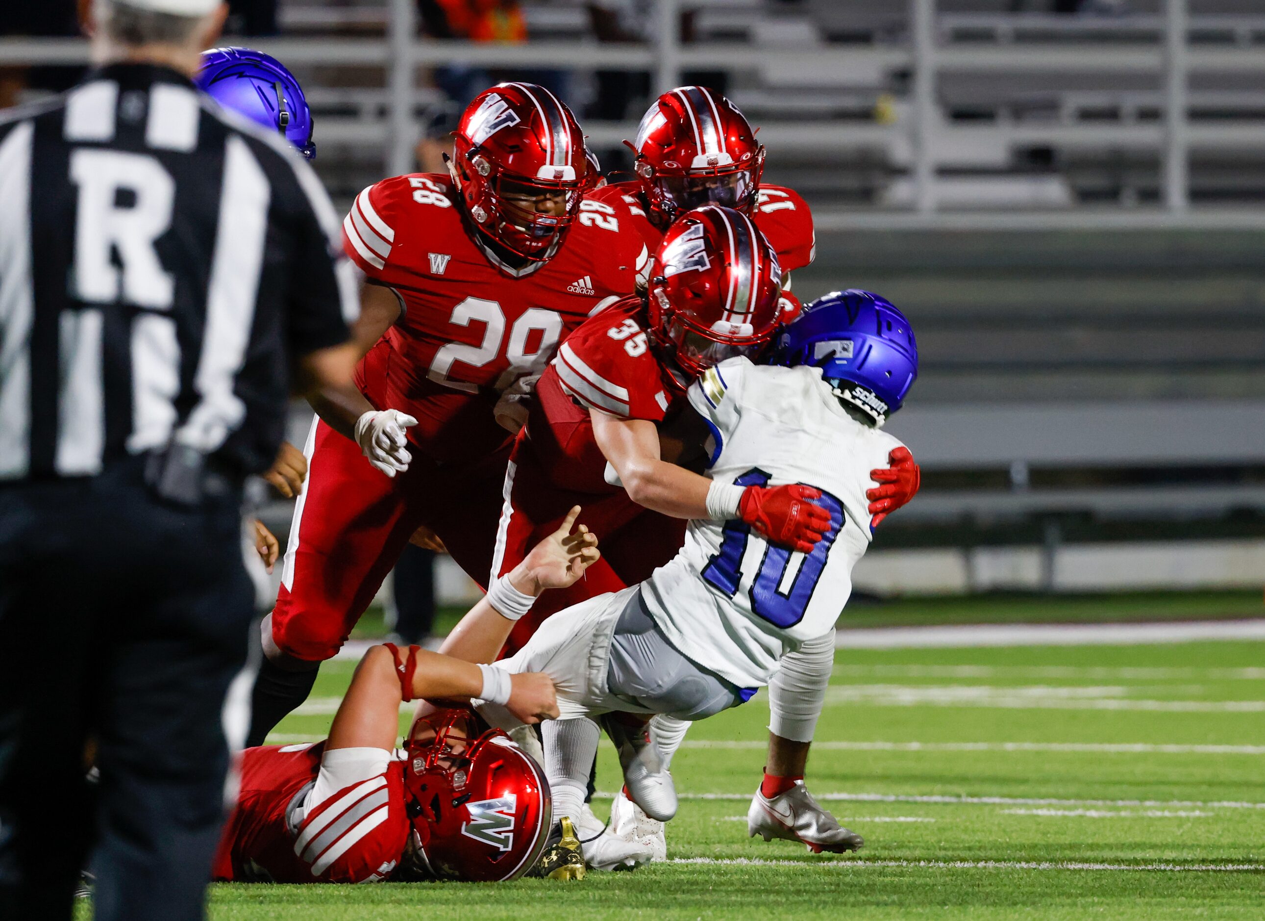 Woodrow Wilson line backer Reece McMillan (35) tackles Conrad wide receiver Christian Byrum...