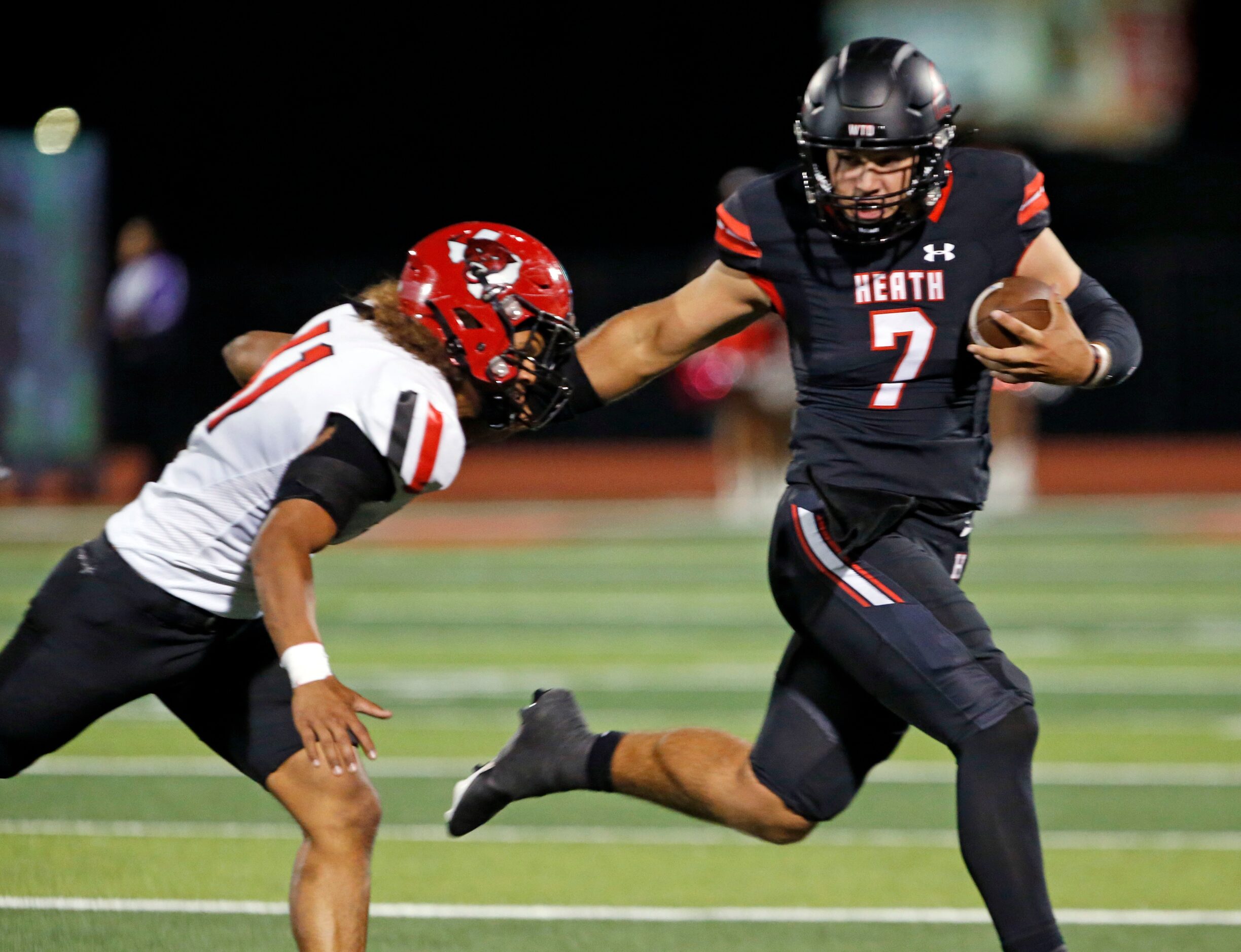 Rockwall Heath QB Caleb Hoover (7) scrambles away from Mesquite Horn defender Alec Hernandez...