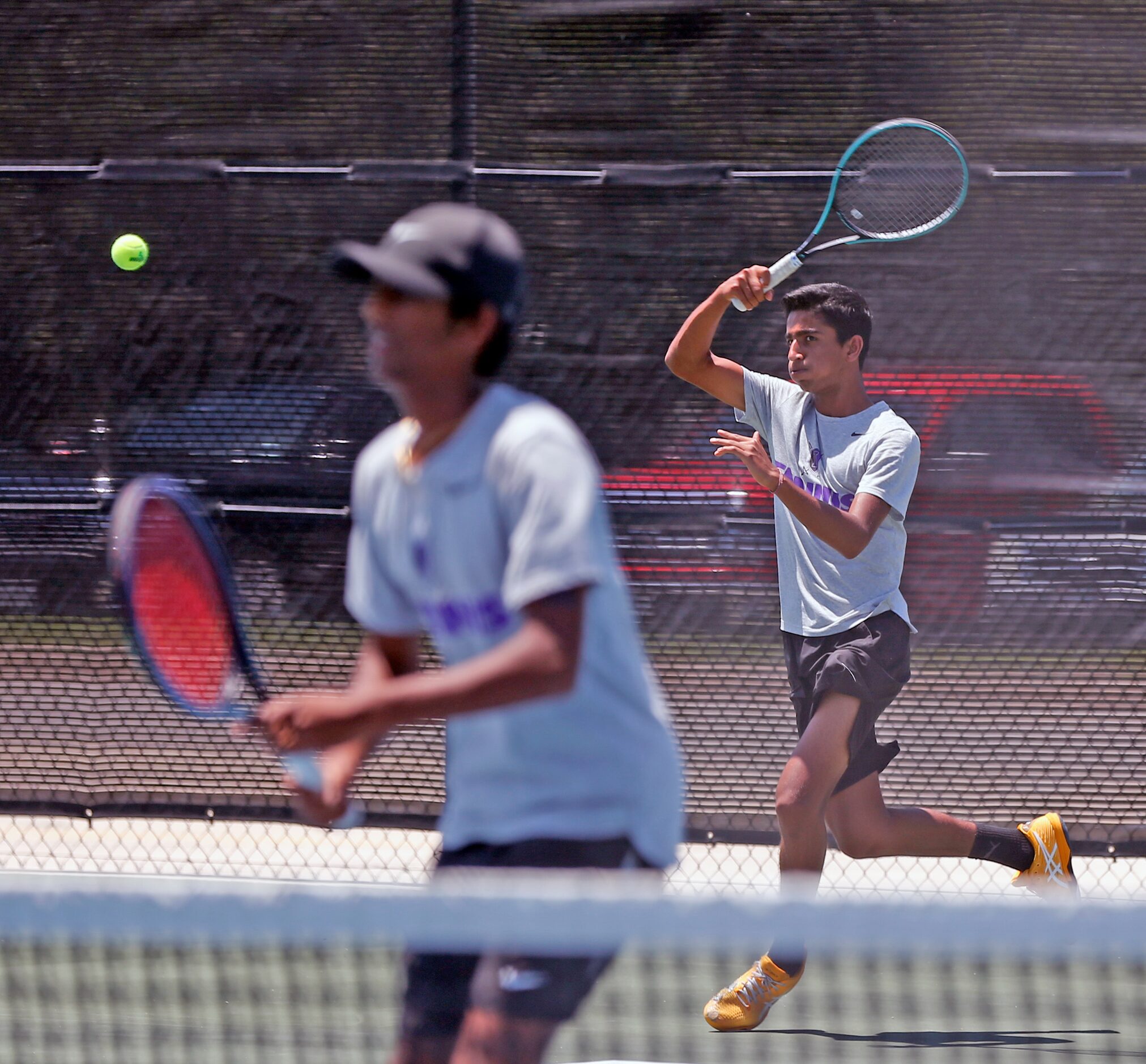 Frisco Independence's Sansh Kumar serves as Sanjaya Kodali waits in a boys 5A doubles match....