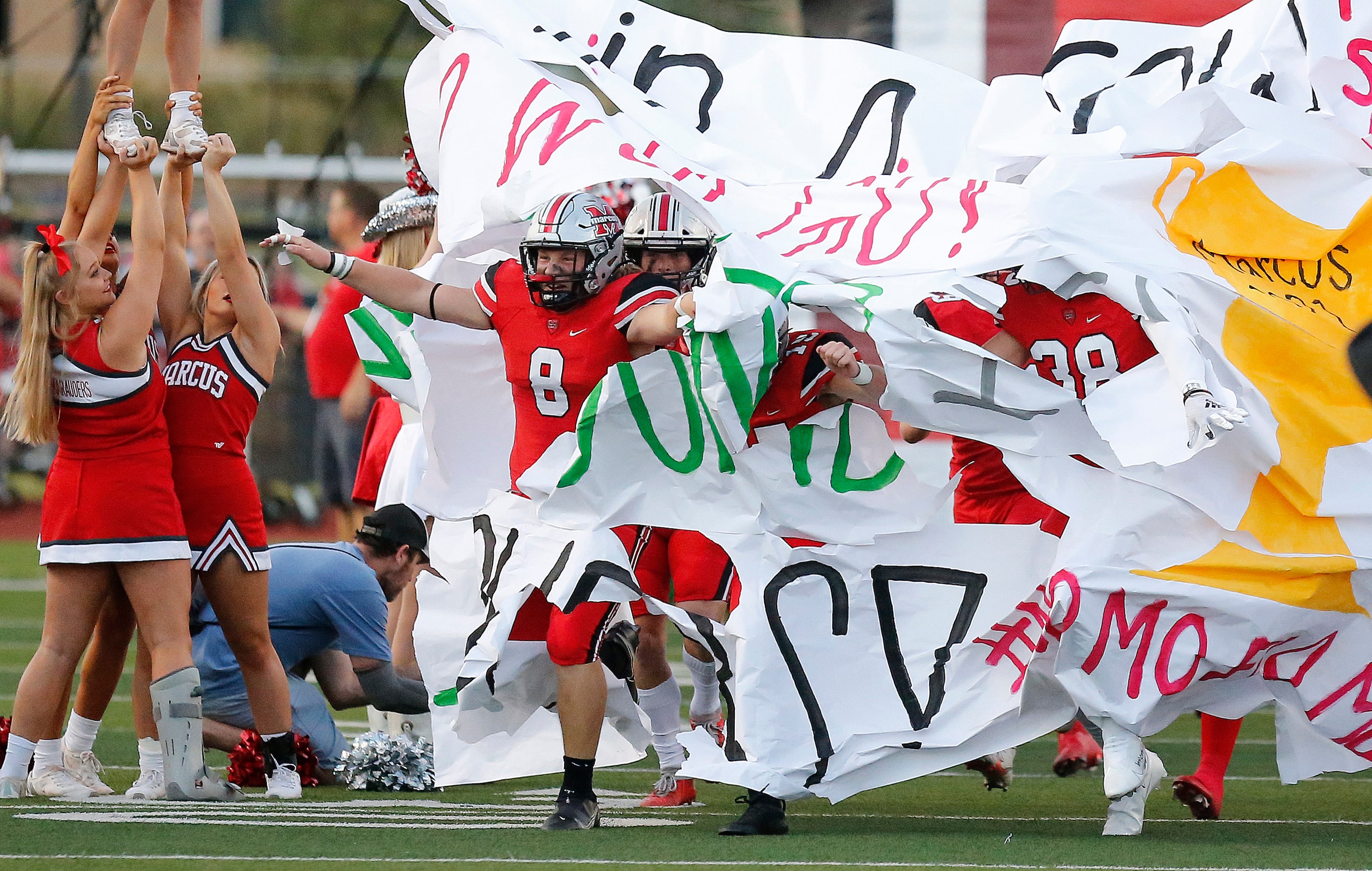 Flower Mound Marcus High School linebacker Jake Jund (8) breaks through the run through...