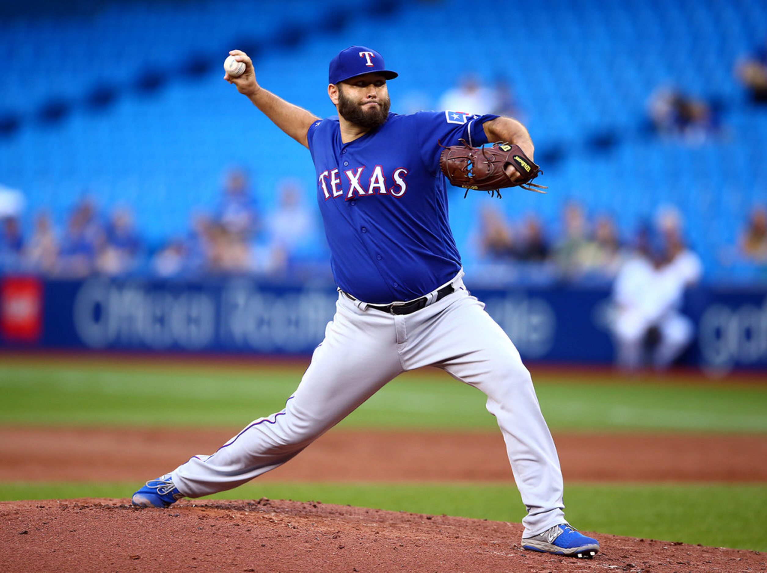 Lance Lynn of the Texas Rangers delivers a pitch in the first inning against the Toronto...