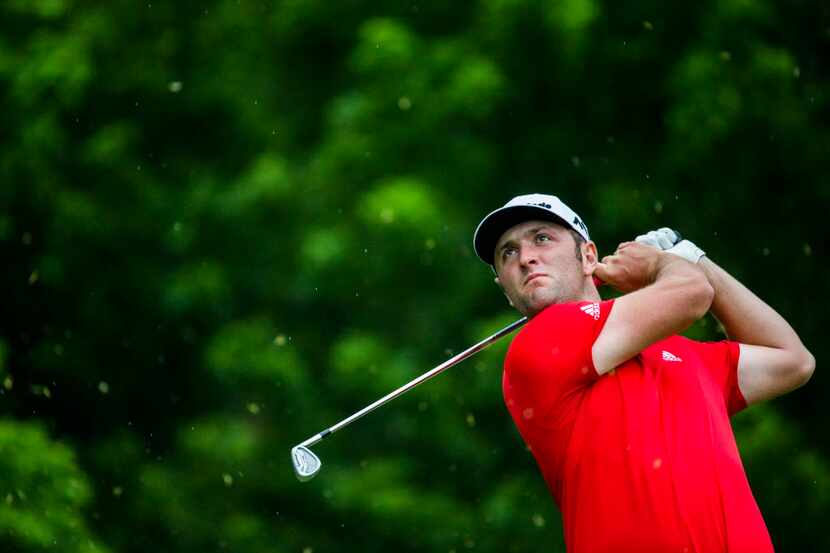 Jon Rahm tees off at the 8th hole during round four of the Dean & Deluca Invitational golf...