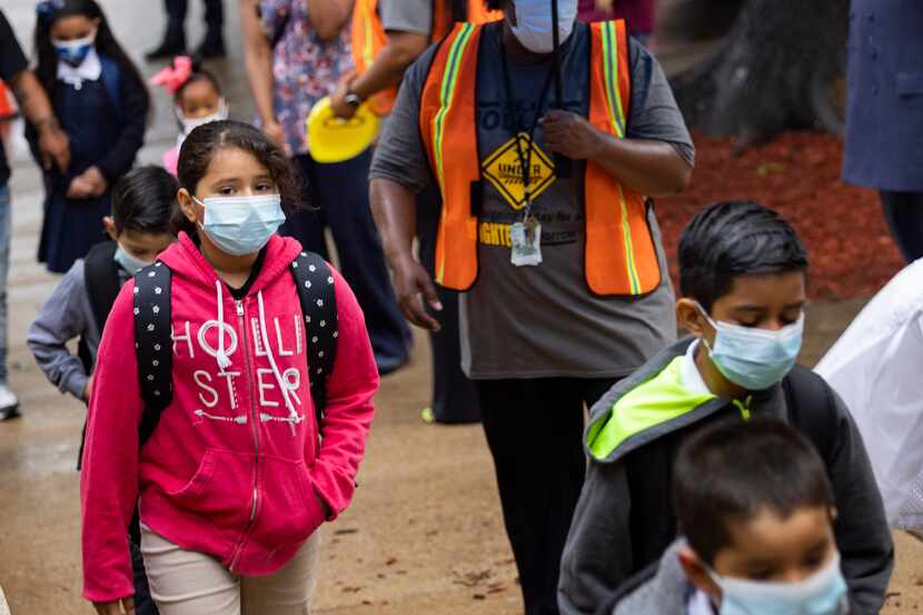 Students wear masks as they head into the first day of school on Monday, Aug. 2, 2021, at...