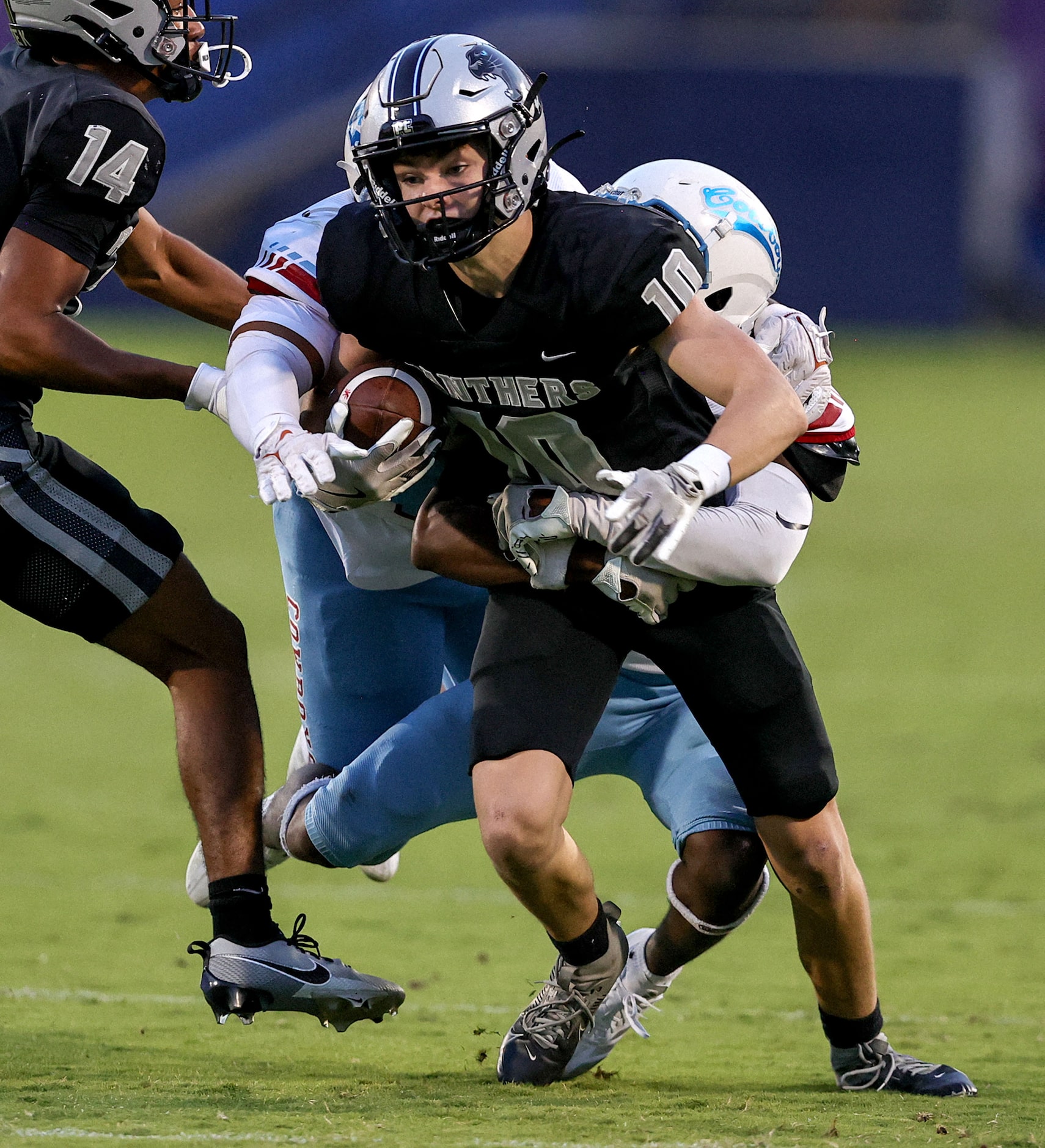 Frisco Panther Creek wide receiver Cody Surratt (10) tries to fight off Dallas Carter...