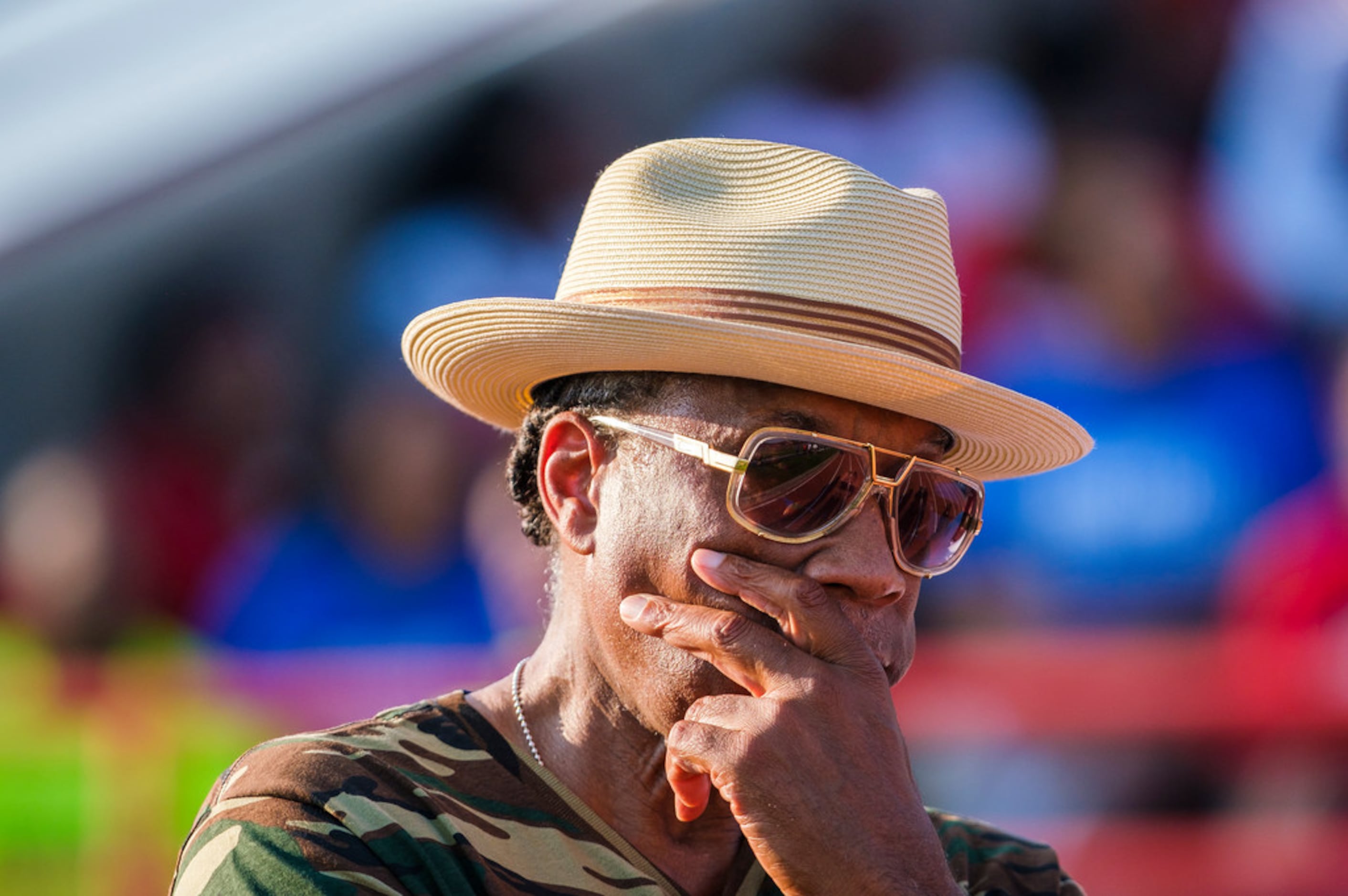 John Wiley Price watches from the sideline during the first half of a high school football...