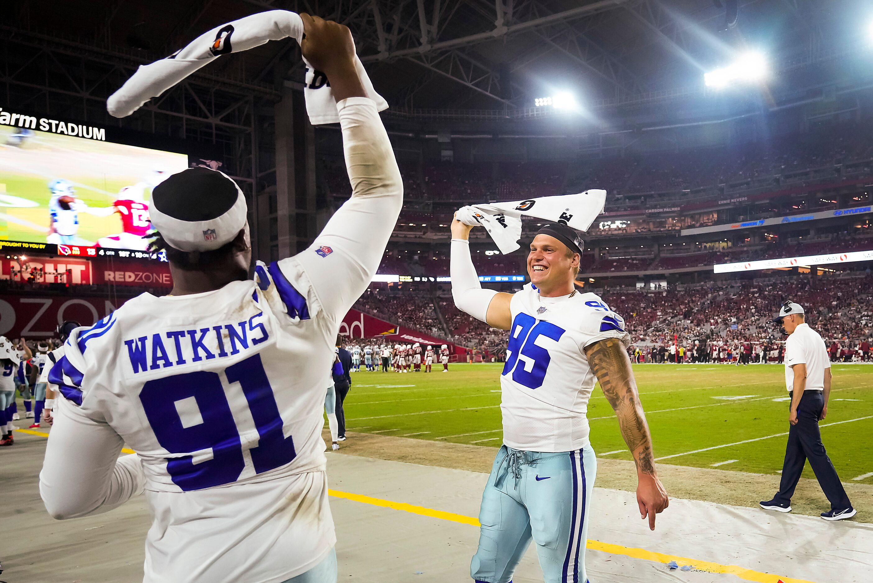 Dallas Cowboys defensive end Brent Urban (95) and defensive end Carlos Watkins (91) wave...