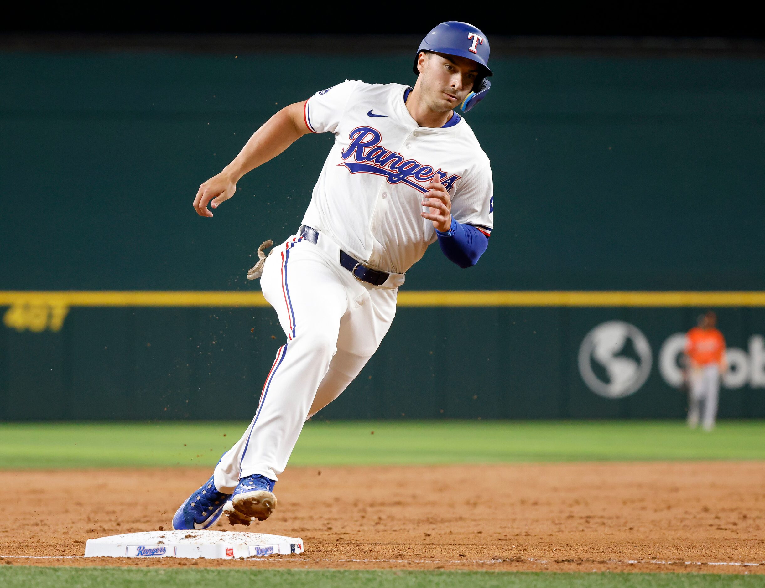 Texas Rangers designated hitter Justin Foscue rounds third before scoring on a Andrew...