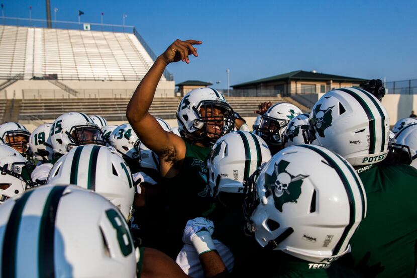 Mesquite Poteet football players get pumped up before a high school football game between...