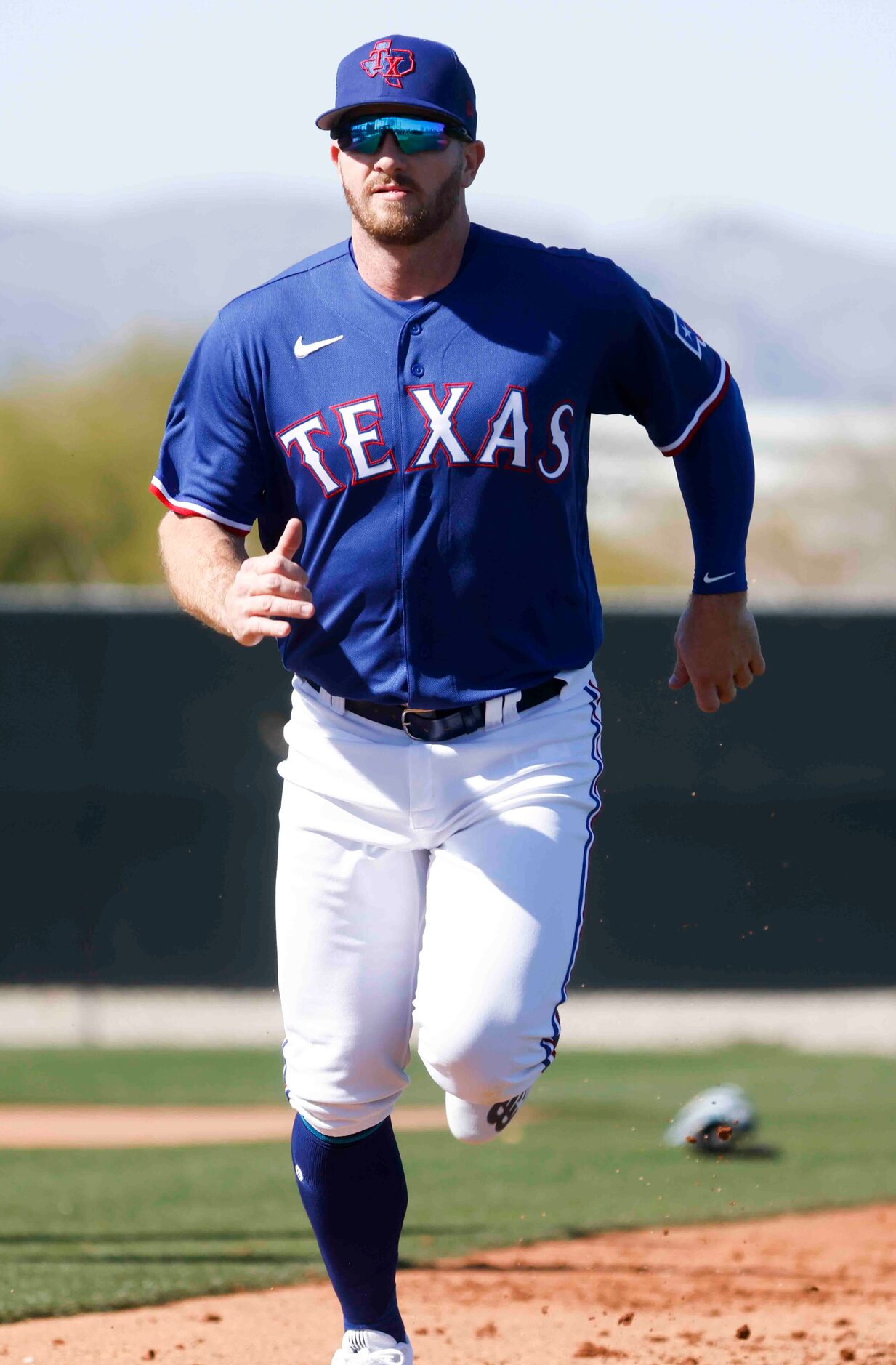 Texas Rangers outfielder Robbie Grossman takes part in a drill during a spring training...