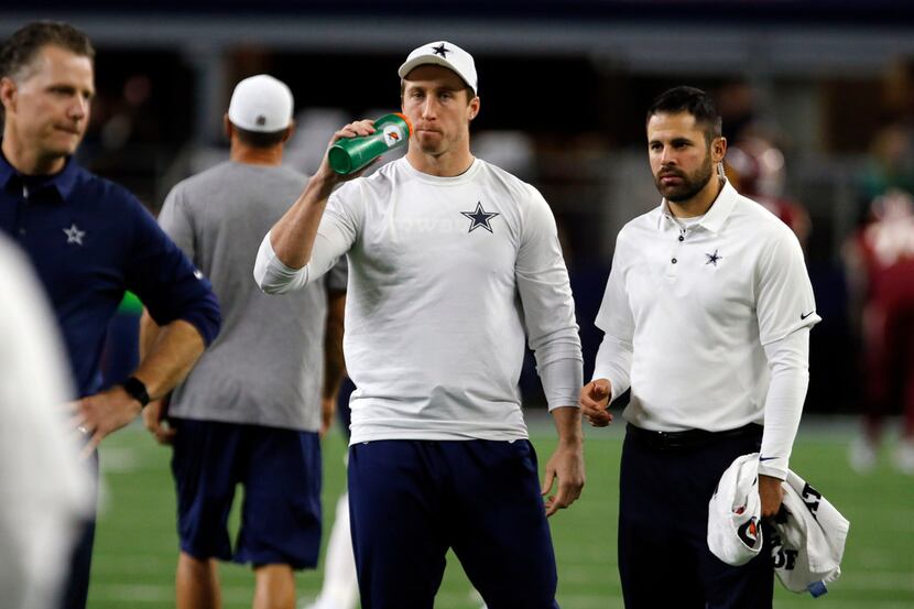 Injured Sean Lee watches workouts before the start of a NFL football game between the...