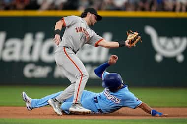 San Francisco Giants shortstop Brett Wisely catches the throw as Texas Rangers' Marcus...