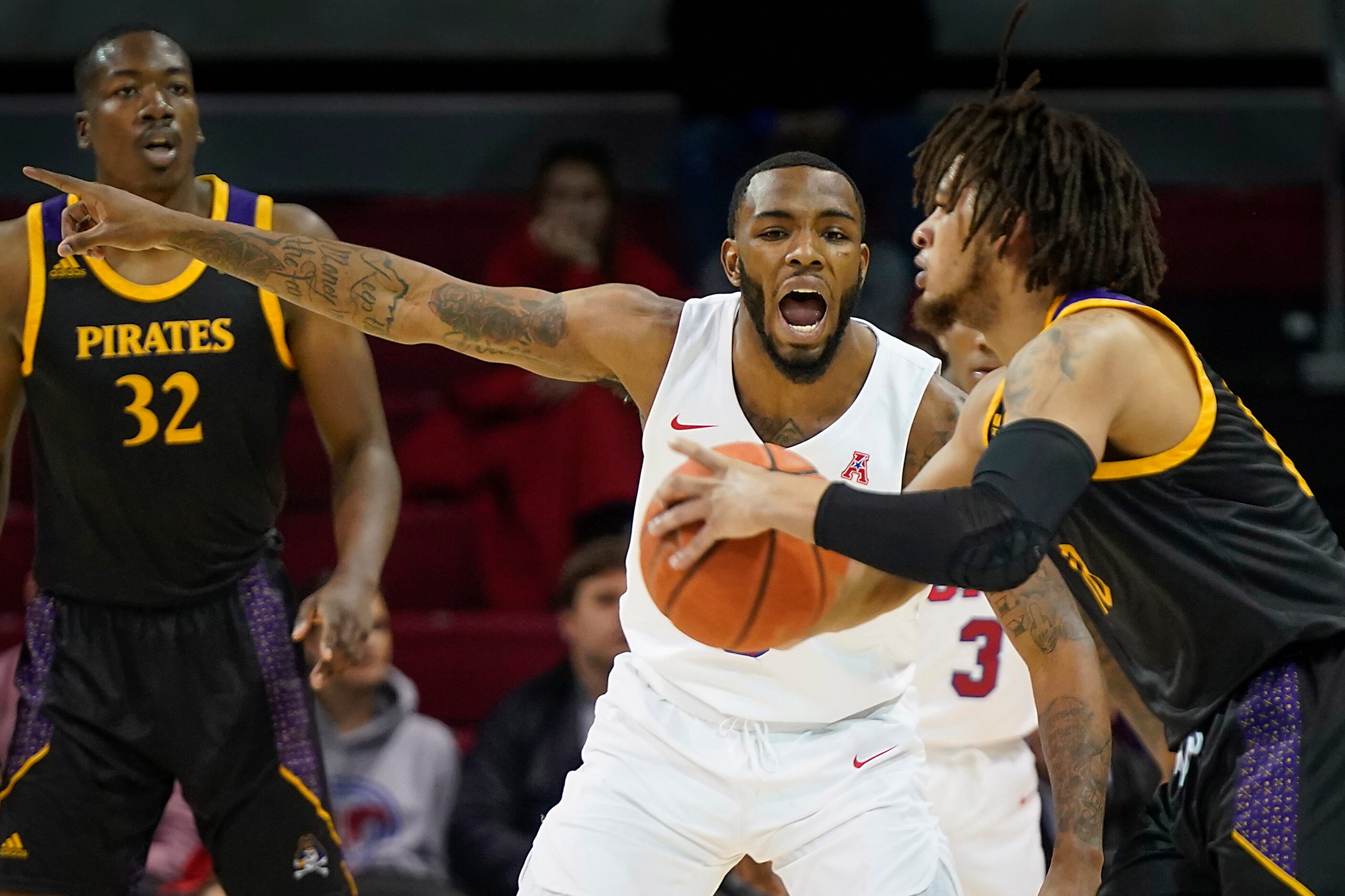 SMU guard Tyson Jolly (0) defends against East Carolina guard Tyrie Jackson during the first...