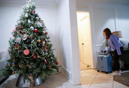 Maggie Welch stands by her father Josh's oxygen machine at their home in Plano on Feb. 24,...