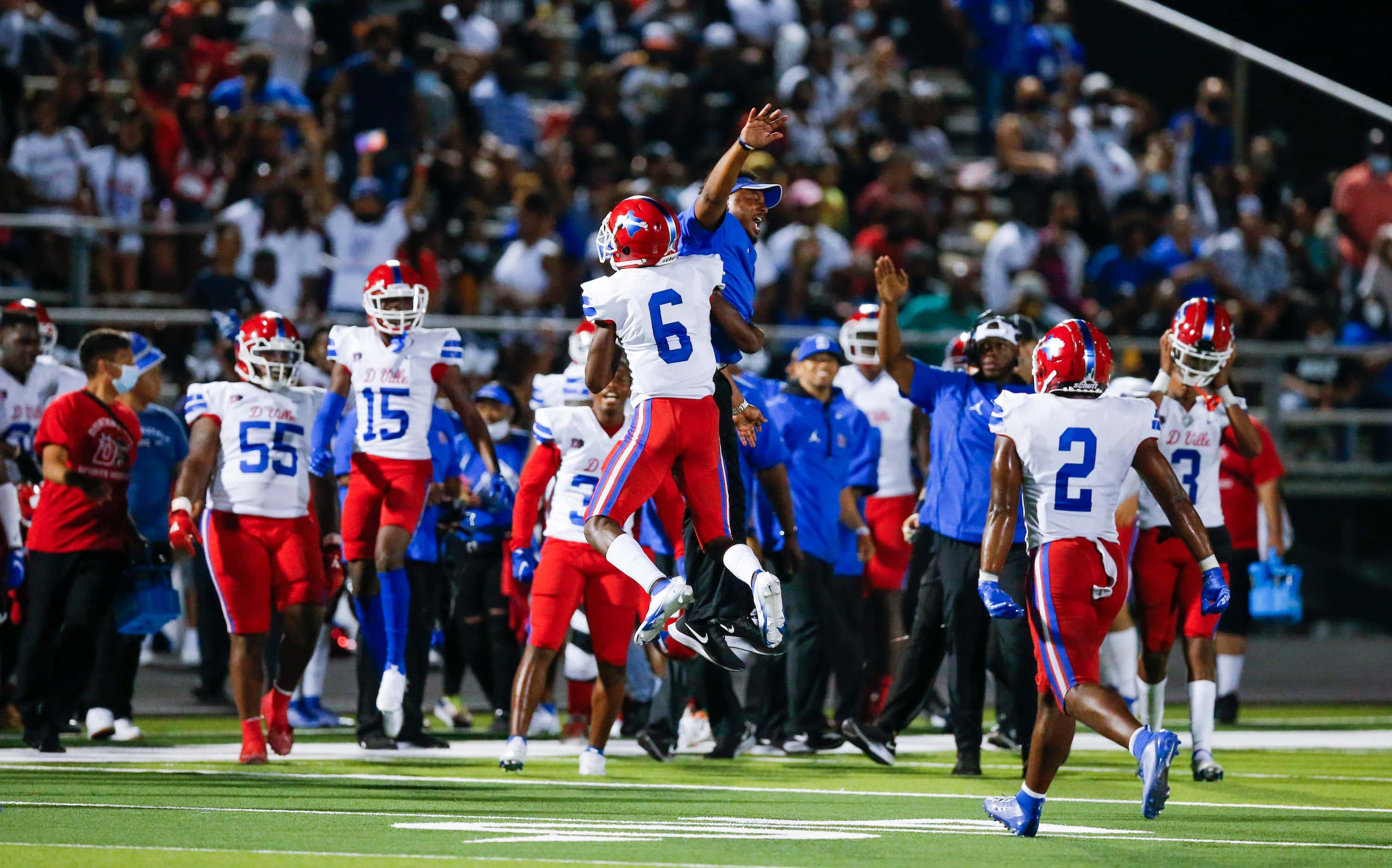 Duncanville senior Da’Myrion Colemman (6) celebrates with coaches and teammates after coming...