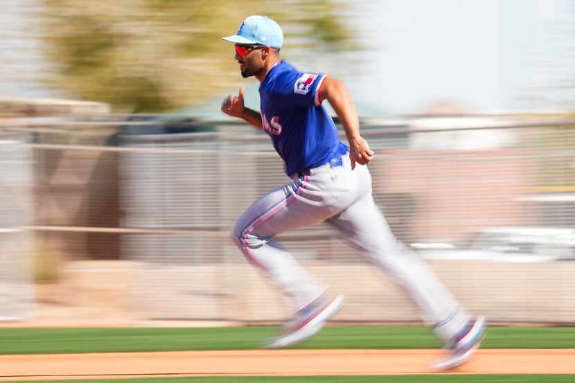 Texas Rangers infielder Marcus Semien participates in a baserunning drill during a spring...