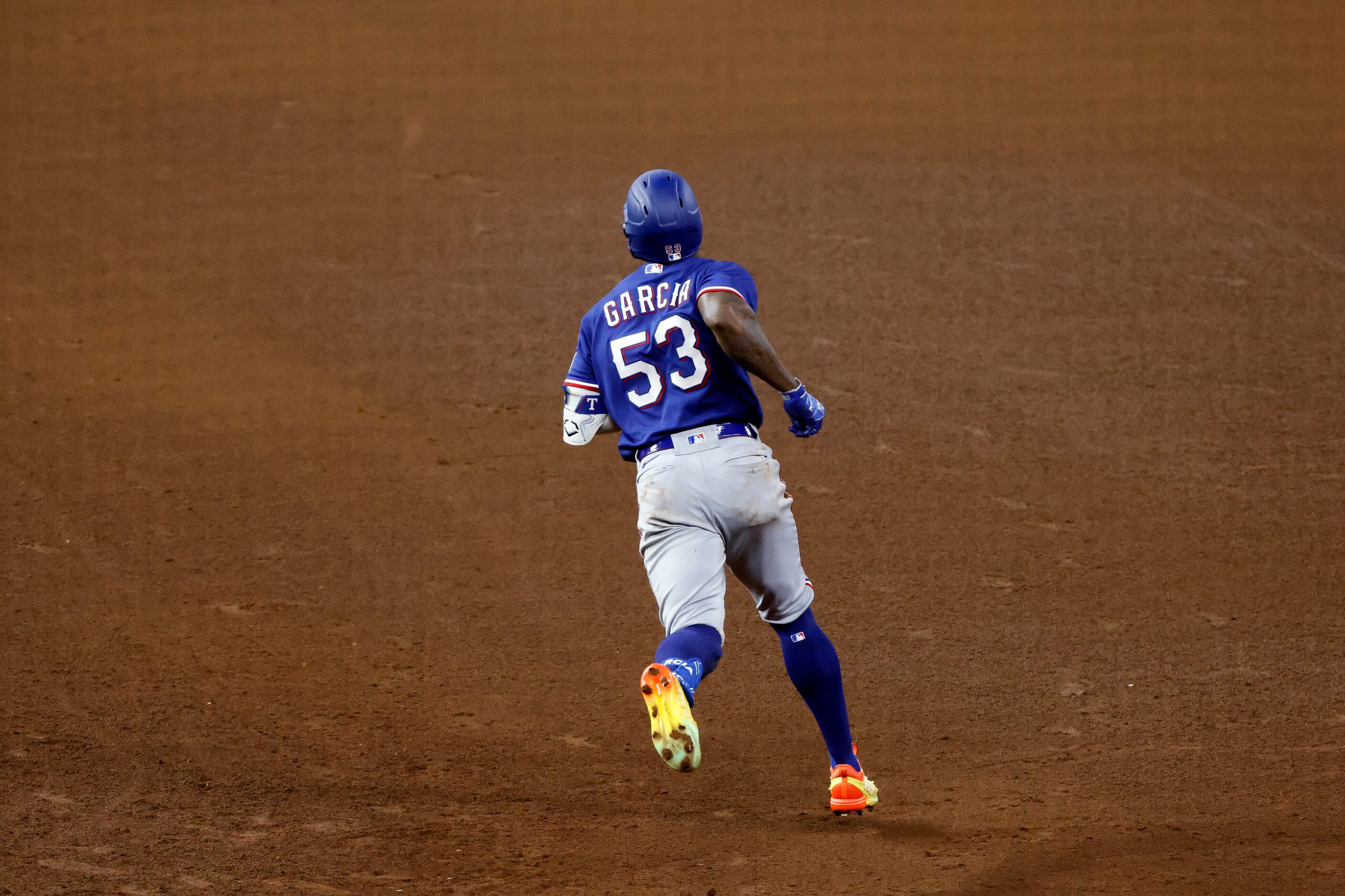 Texas Rangers Adolis Garcia (53) rounds first after hitting an eighth inning home run in...