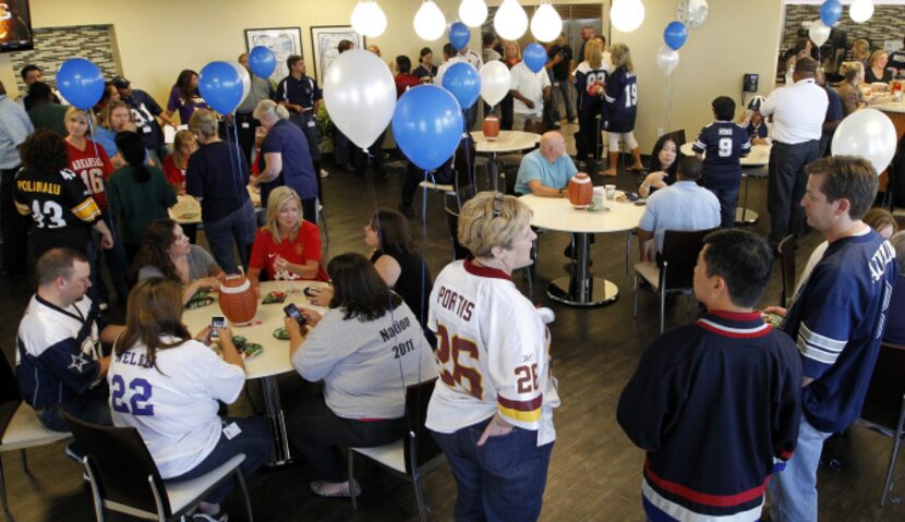 Employees of Alliance Data take part in the Fun Bunch Fall Football Season Kick-off in their...