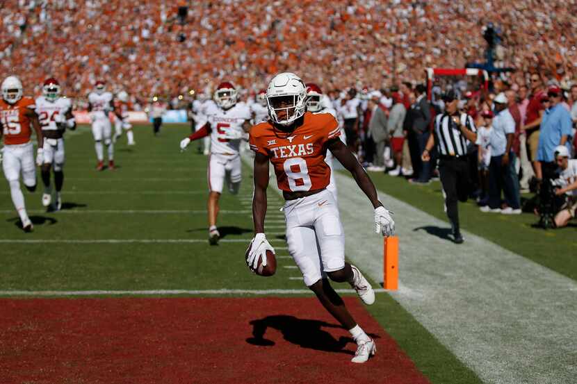 Texas wide receiver Xavier Worthy (8) scores a touchdown during the first half of an NCAA...