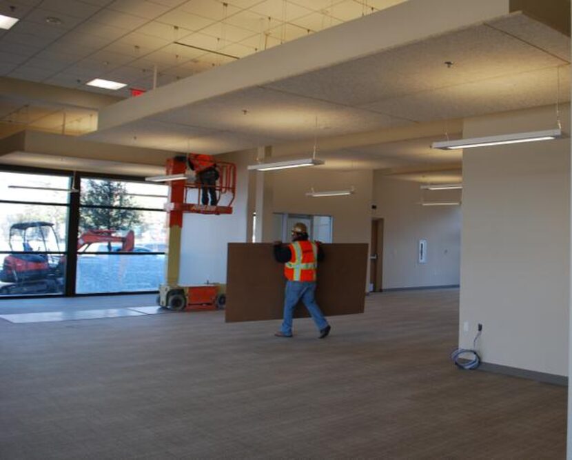 Crew members work on the finishing touches inside Dallas CASA’s new facility. The nonprofit...