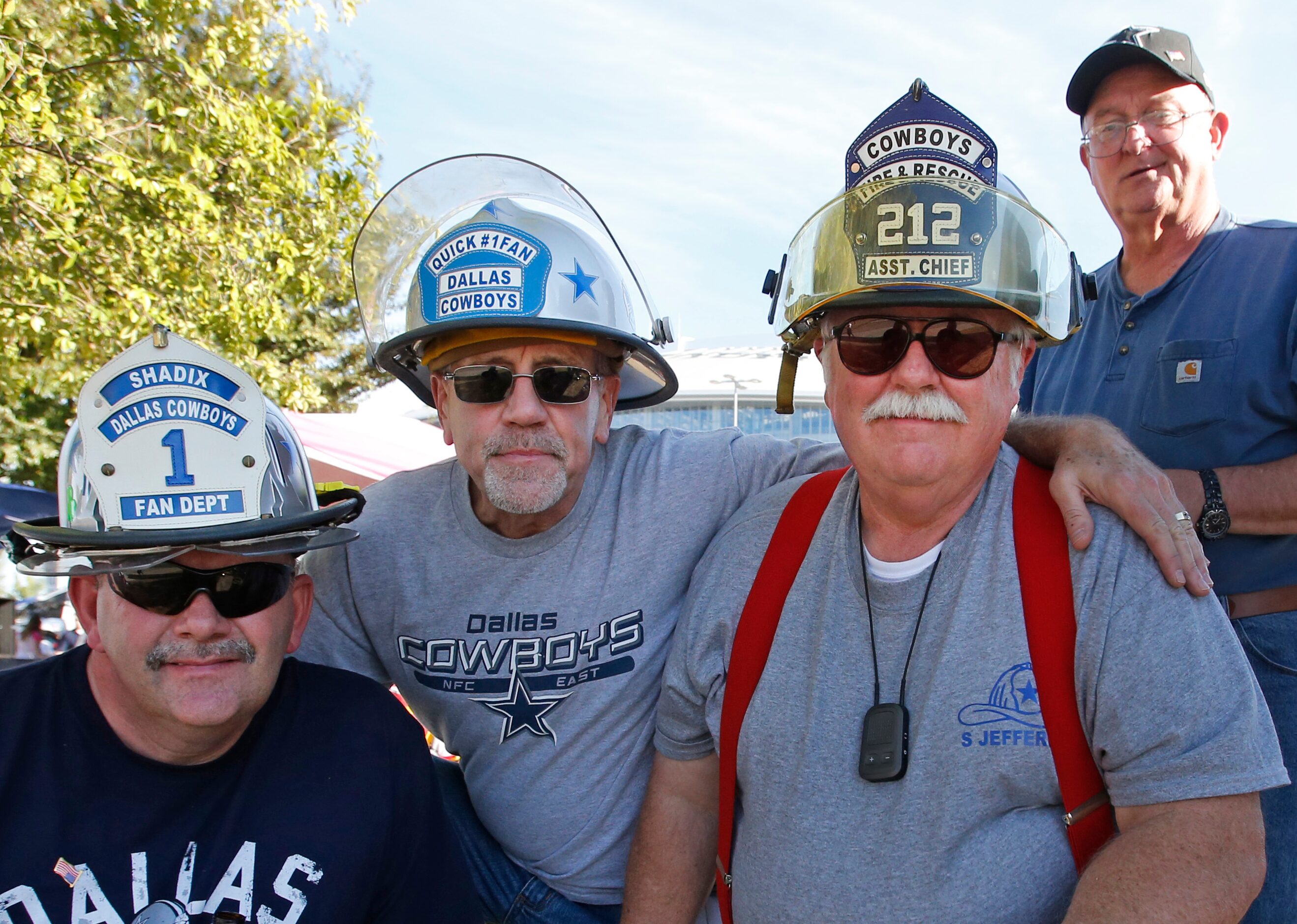 Ron Shadix, Richard Quick Steve Jeffers and Steve Early pose with their fireman-themed hats...