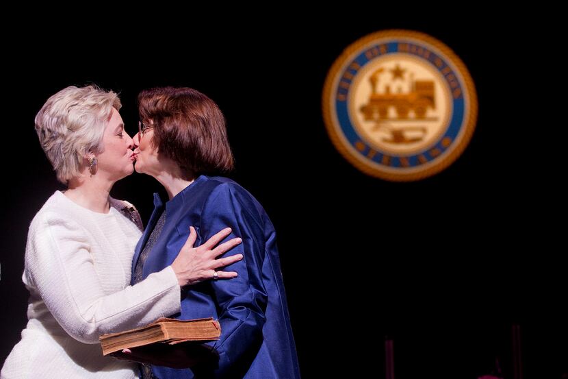 Houston Mayor Annise Parker,left, kisses her partner Kathy Hubbard after Parker was sworn in...