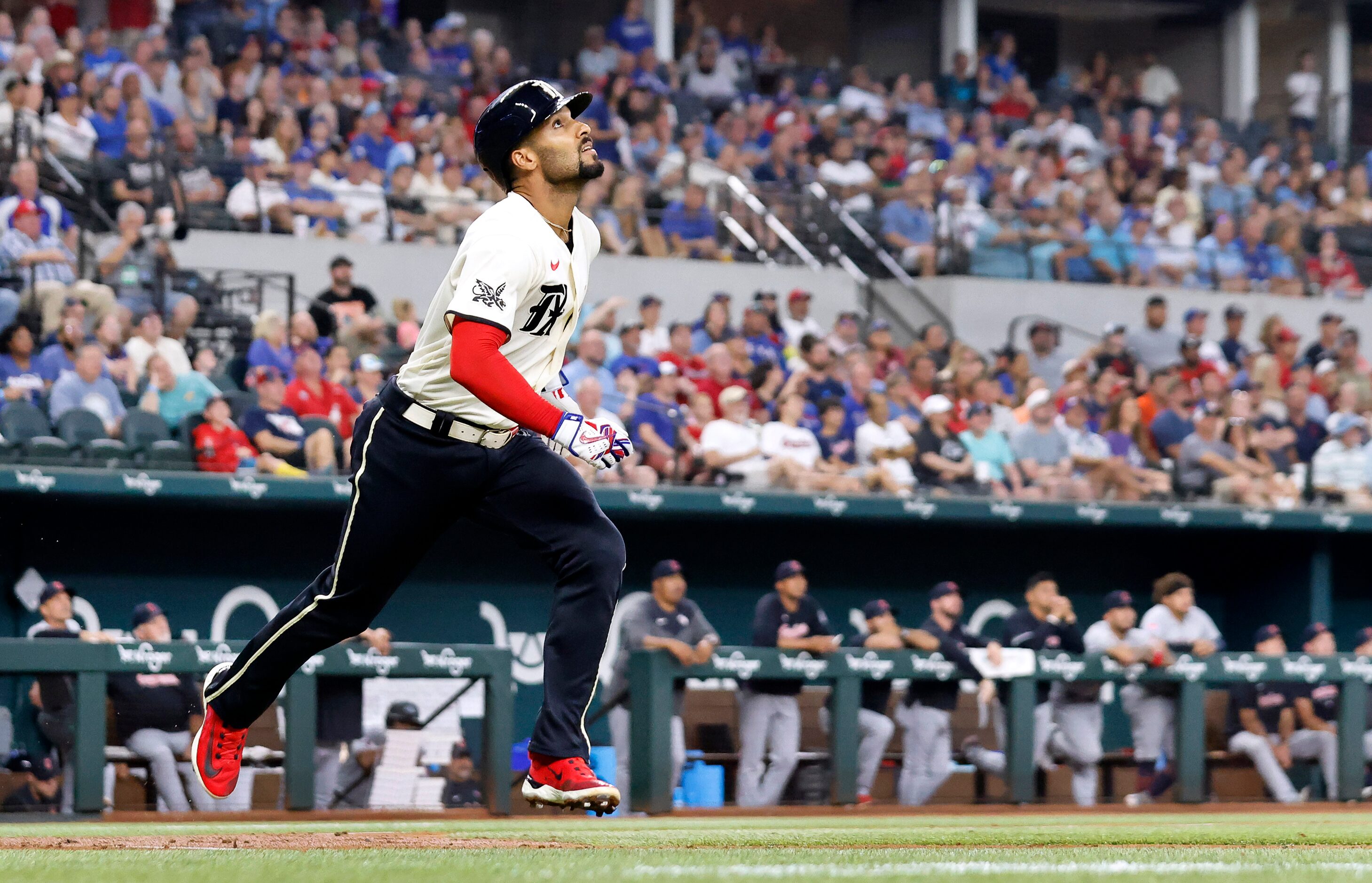 Texas Rangers batter Marcus Semien (2) watches his unexpected sacrifice fly during the...