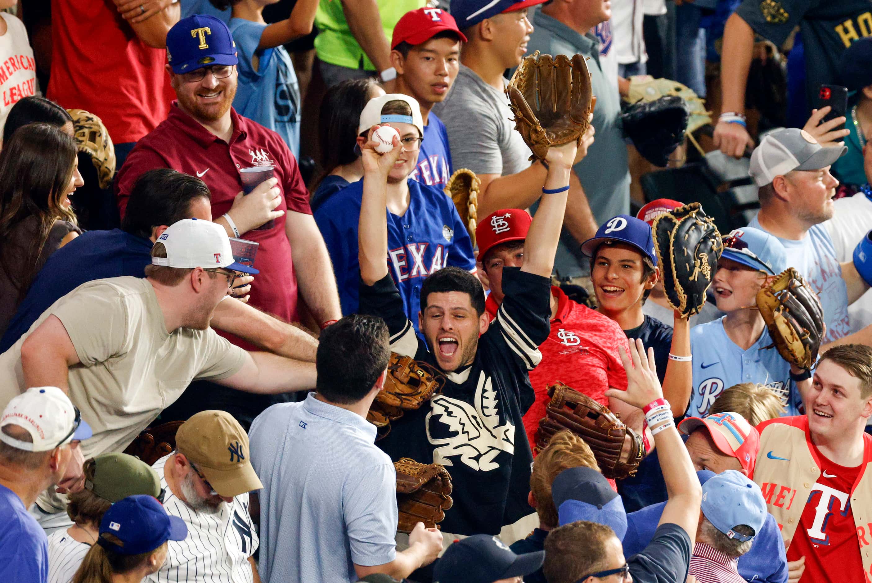 A fan reacts after catching a home run from American League's José Ramírez, of the Cleveland...