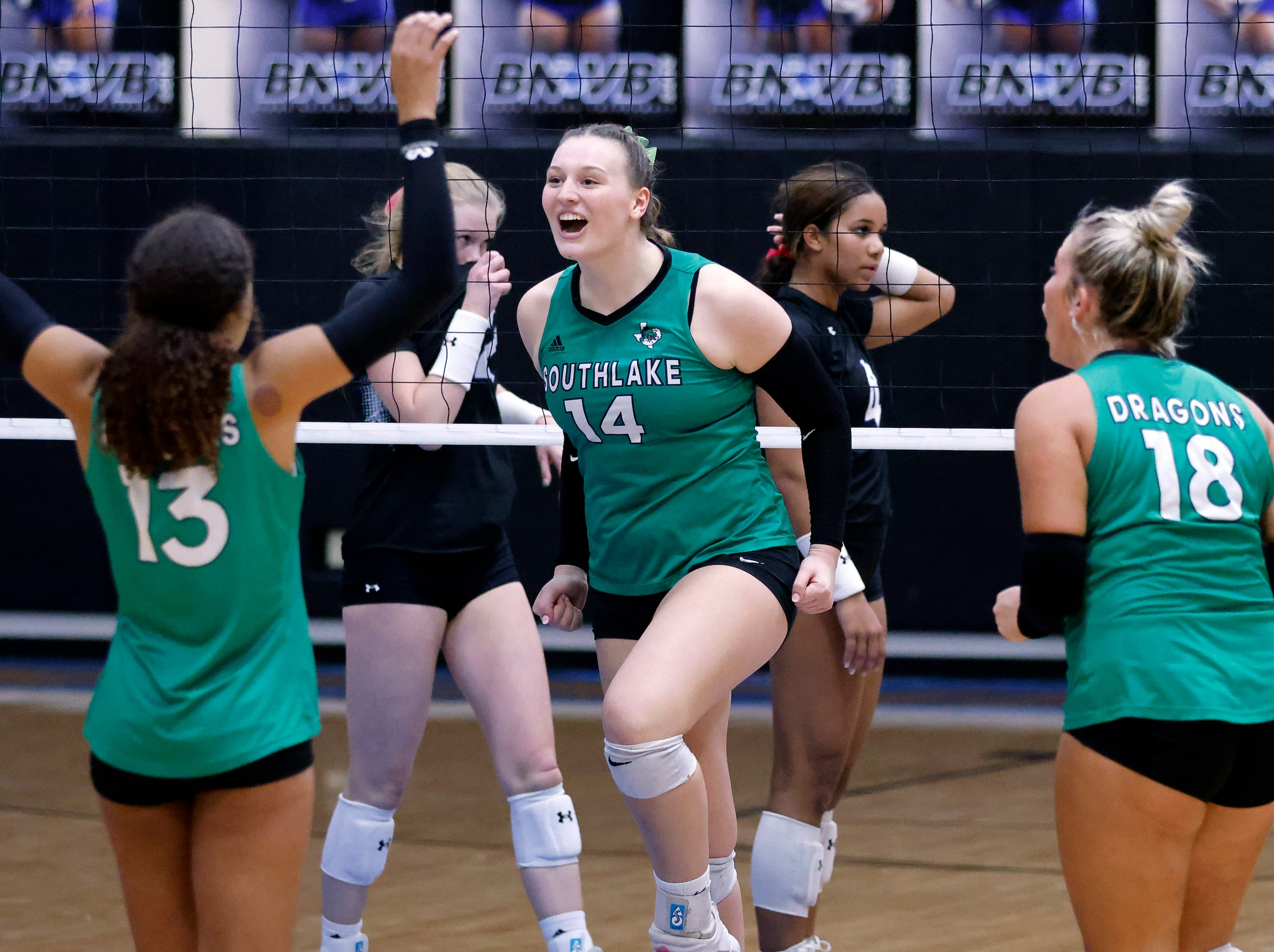 Southlake Carroll middle blocker Kinsley Young (14) and her teammates celebrate a point...