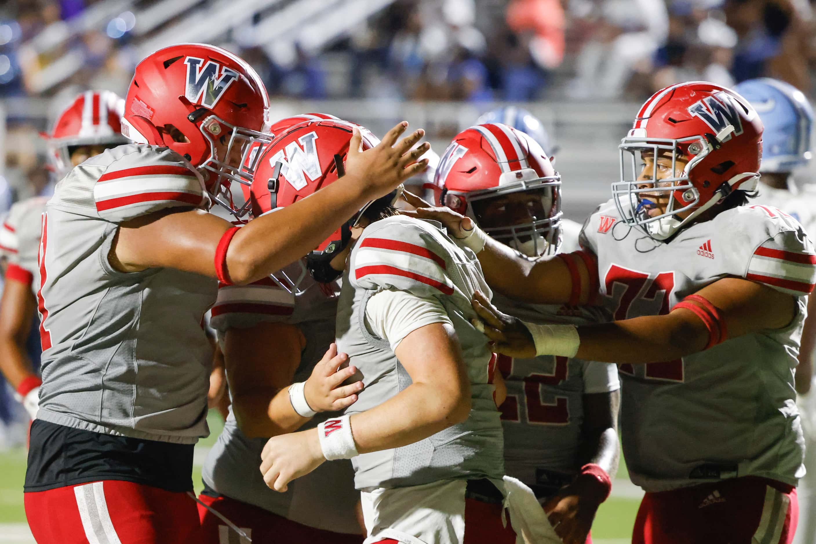Woodrow Wilson players celebrate a touchdown by QB Cam McGuire during the second half of a...