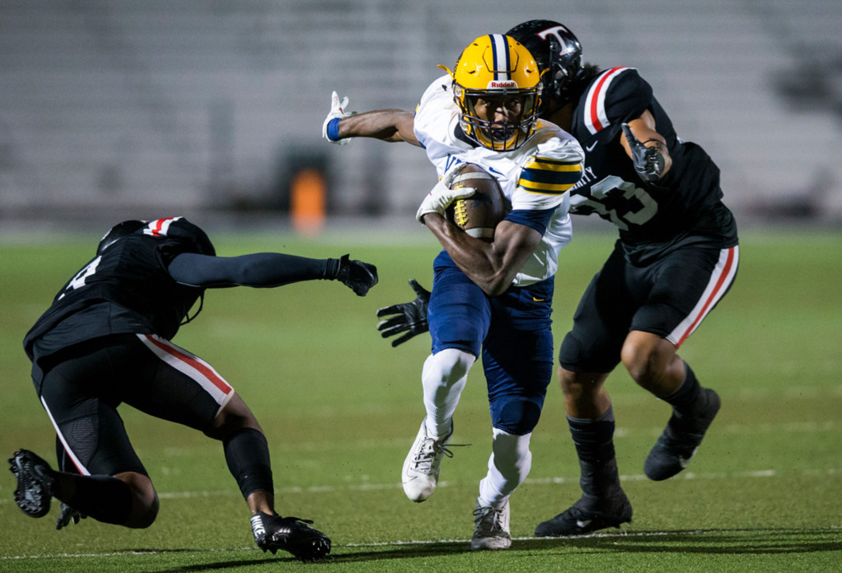 Arlington Lamar wide receiver Trevon West (19) avoids a tackle attempt by Euless Trinity...