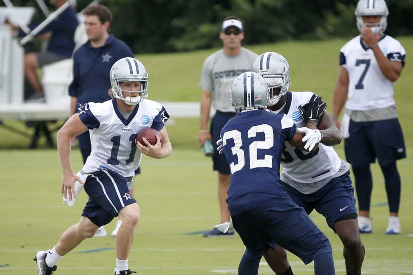 Dallas Cowboys wide receiver Cole Beasley (11) runs after a catch as Dez Bryant (88) blocks...