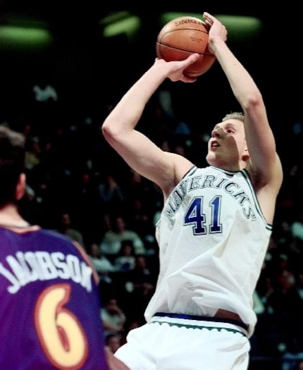 FILE - Dallas Mavericks forward Dirk Nowitzki (41) leans back as he puts up a shot over...