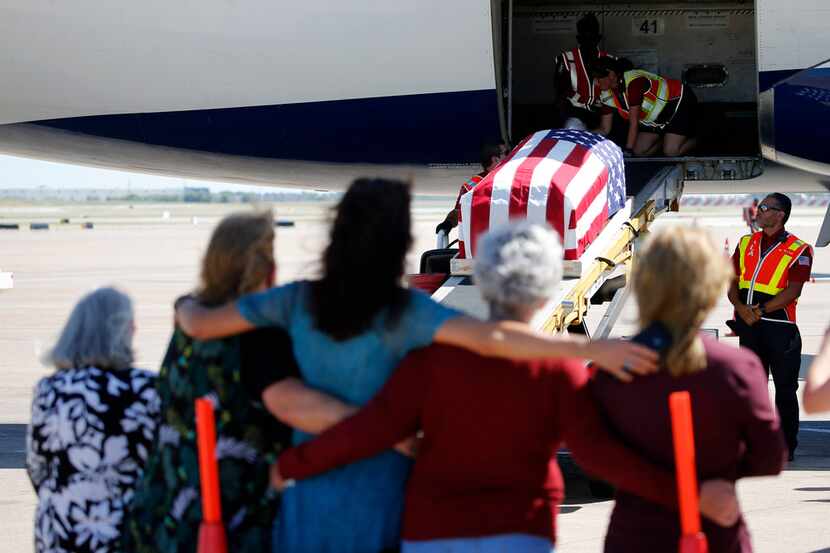 Family and friends watch as the remains of Marine Corps  Pfc. Grady J. Crawford at DFW...