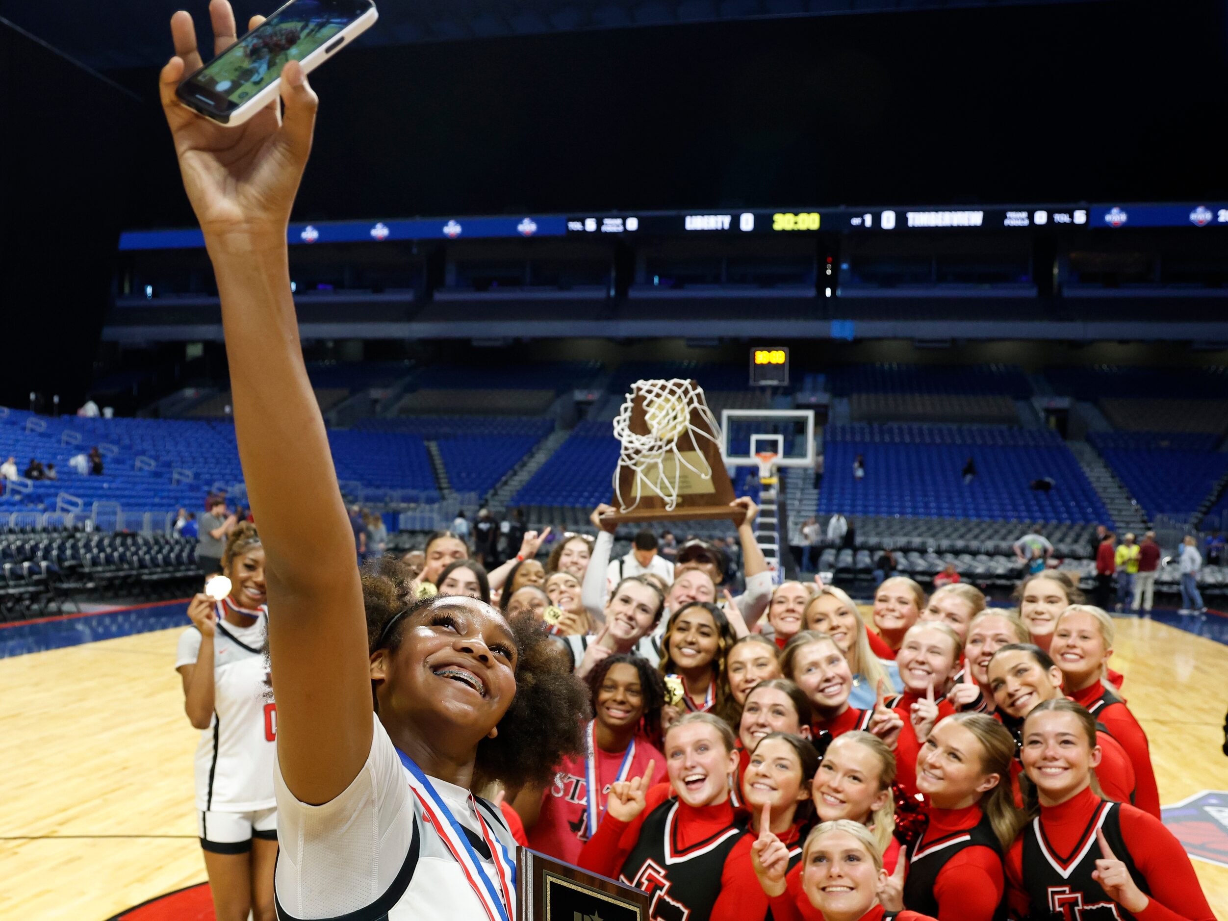 Members of the Frisco Liberty girls basketball team celebrate their UIL Class 5A state...