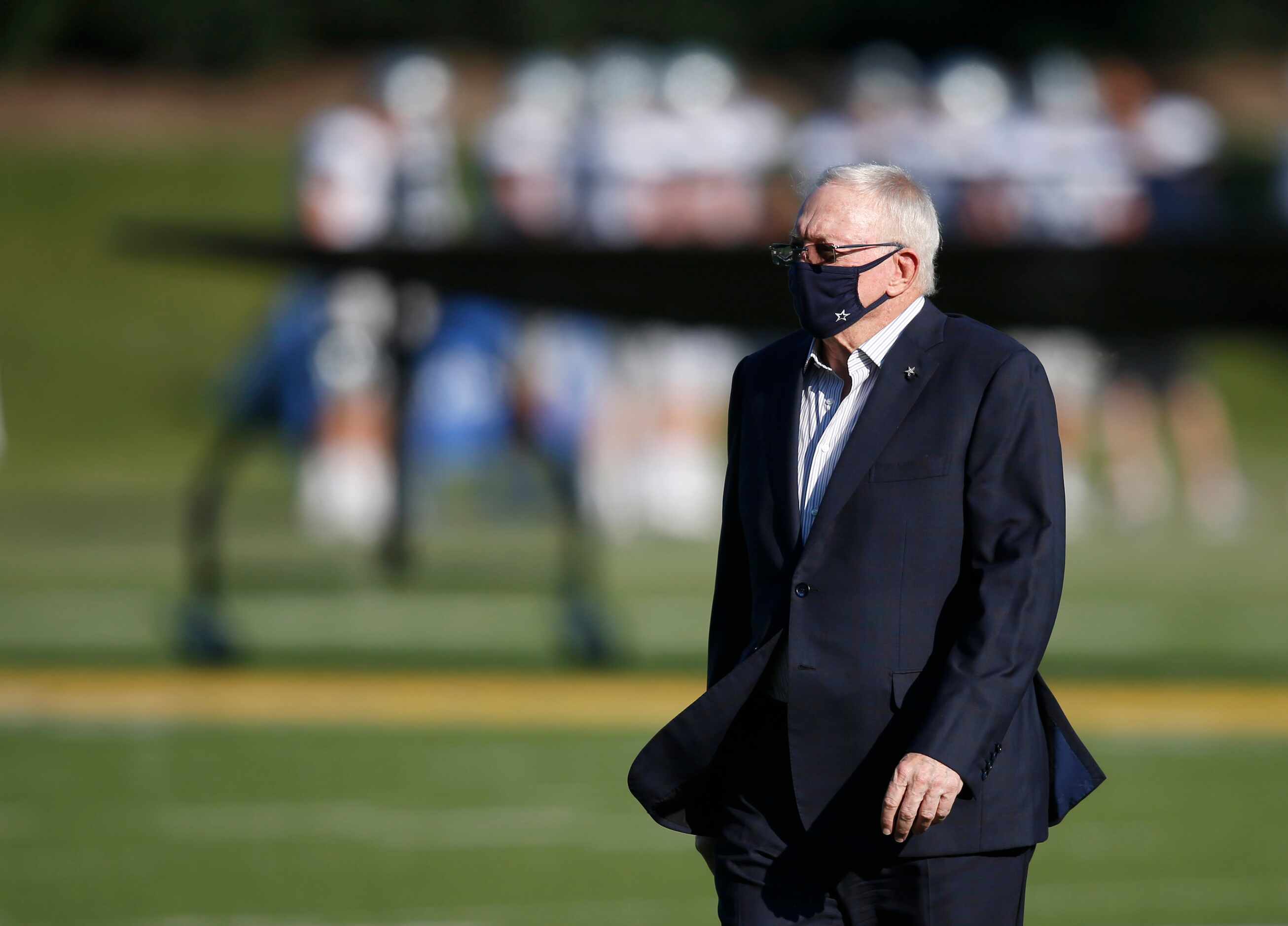 Dallas Cowboys owner and general manager Jerry Jones walks across the field during training...