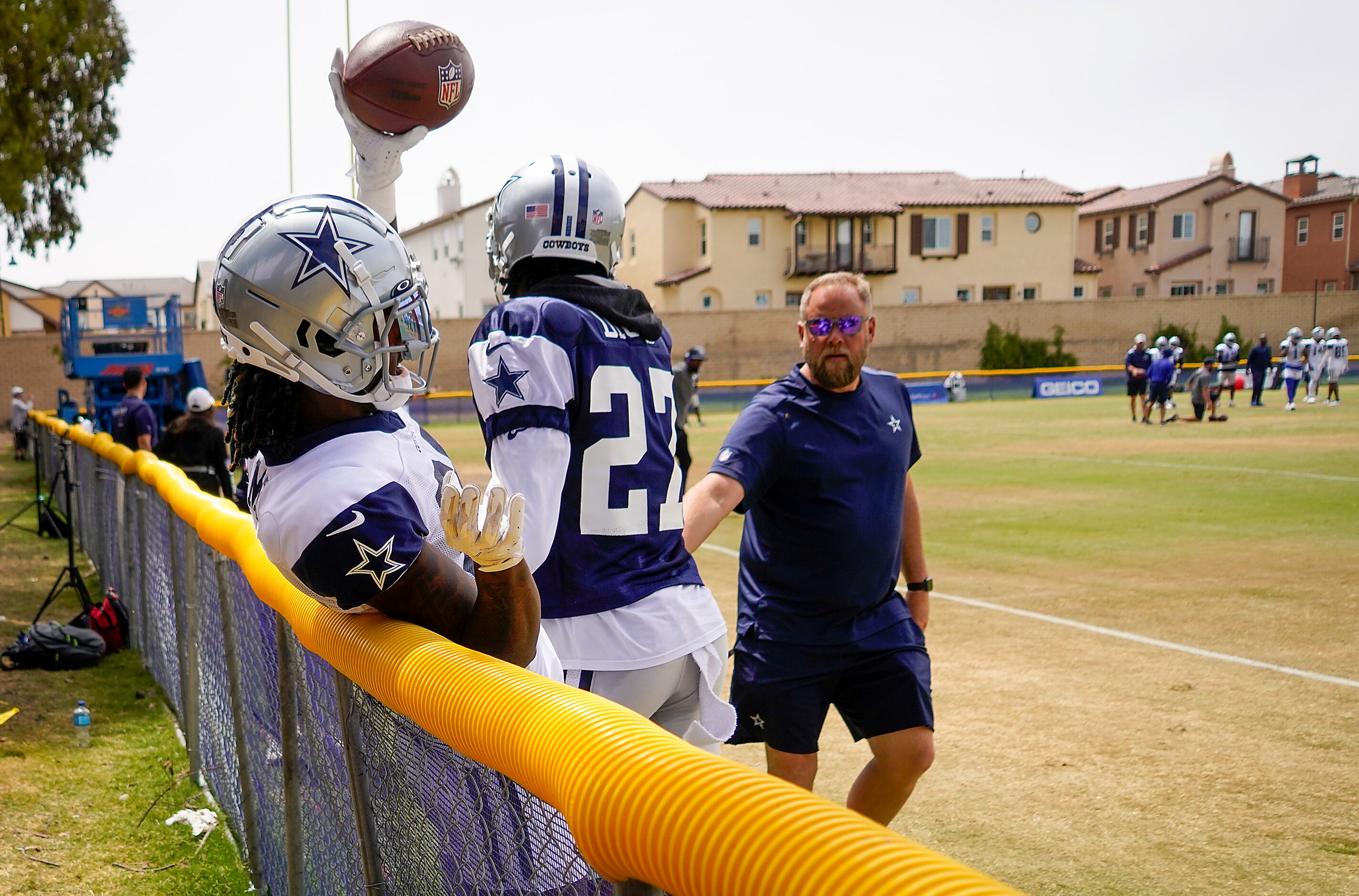 Dallas Cowboys wide receiver CeeDee Lamb (88) collides with a fence after catching a pass...