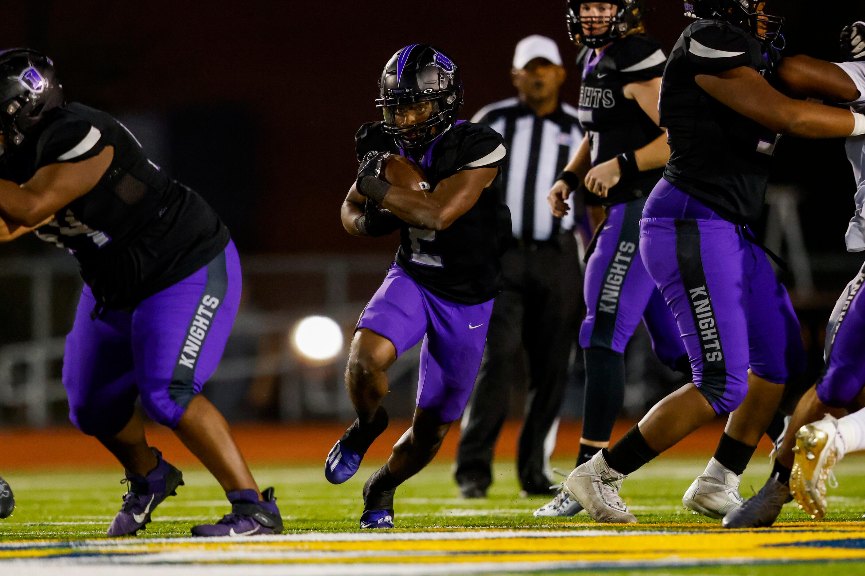 Frisco Independence’s running back Ude Enyeribe (2) runs through a window against the Denton...