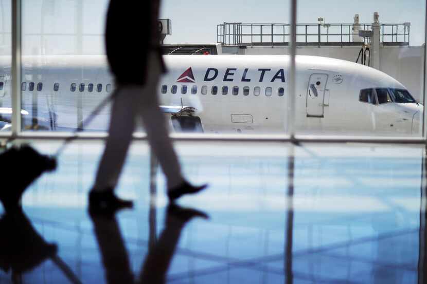 FILE - In this Oct. 13, 2016 file photo, a Delta Air Lines jet sits at a gate at...