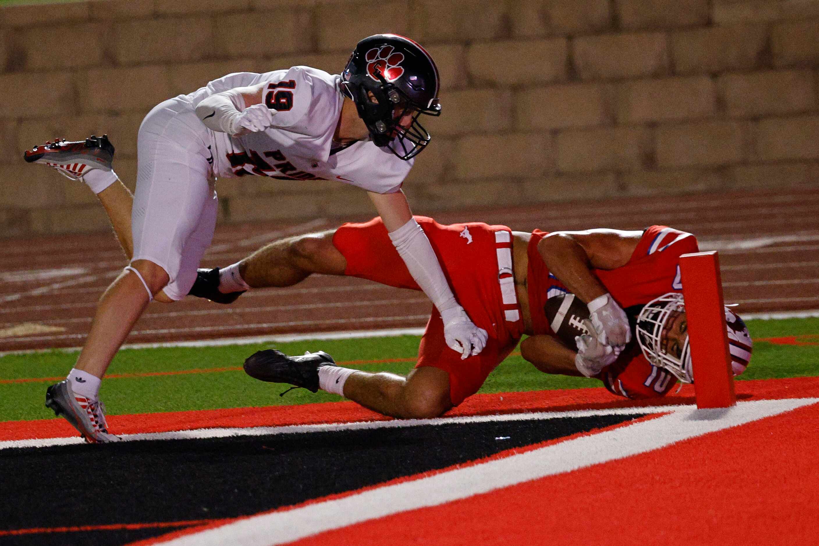 Grapevine's Will Matheny (10) fails to score against Colleyville Heritage's Alex Burk (19)...