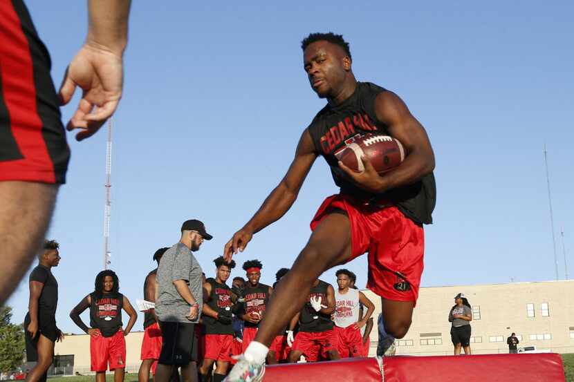 Marquis Forman runs through drills during the first day of football practice at Cedar Hill...