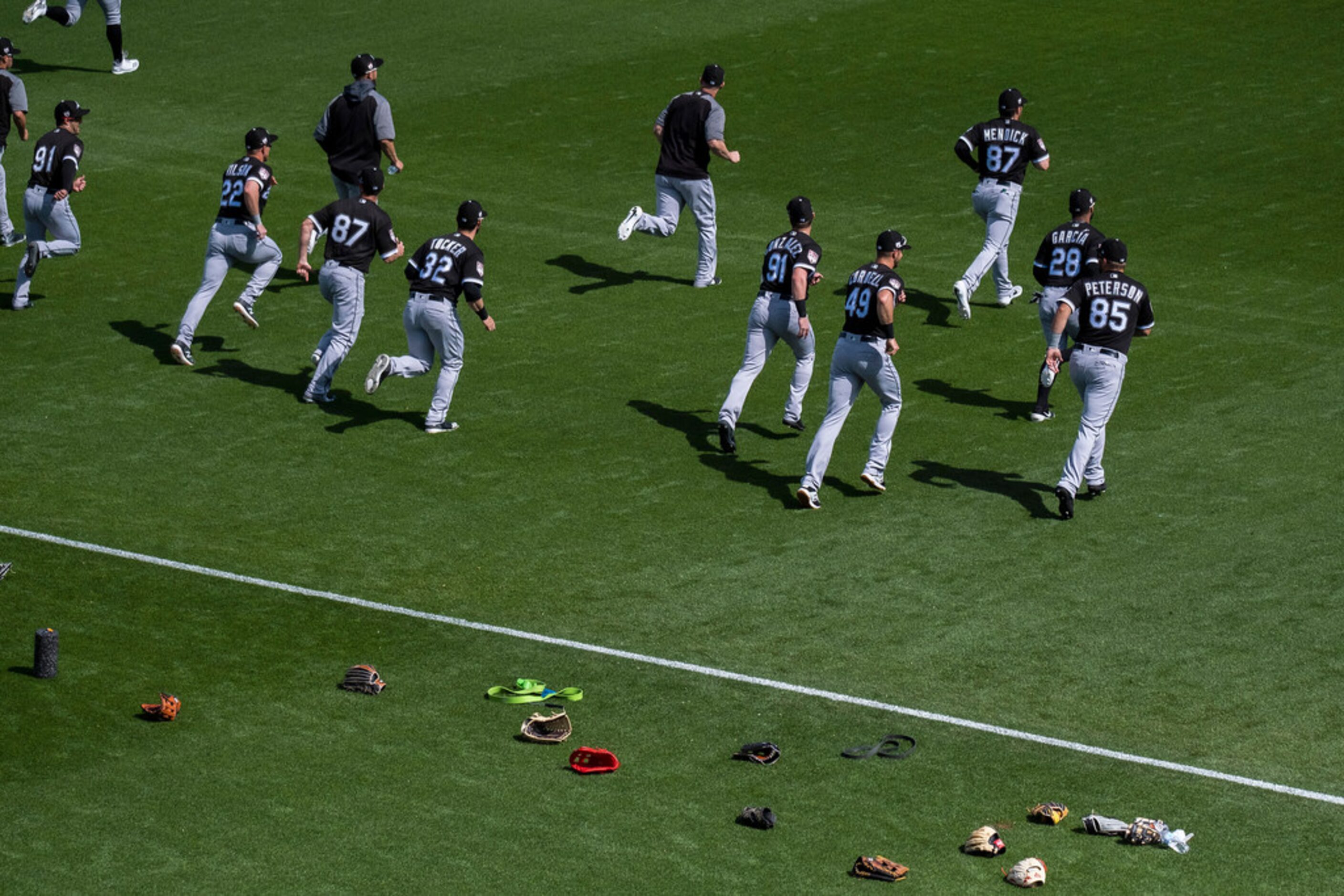 Chicago White Sox players warm up before a spring training baseball game against the Texas...