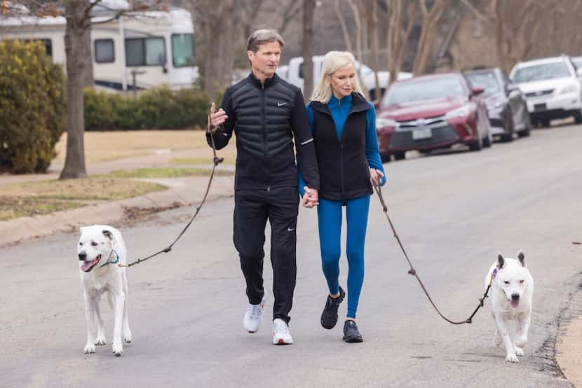 Susan Hawk and her husband, Dr. John Geiser, walk their dogs, Murray (left) and Dickens, in...