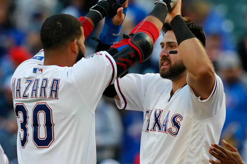 Texas Rangers Joey Gallo, right, is congratulated by teammate Nomar Mazara (30) after...