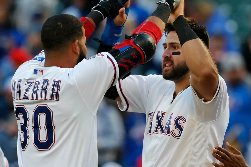Texas Rangers Joey Gallo, right, is congratulated by teammate Nomar Mazara (30) after...