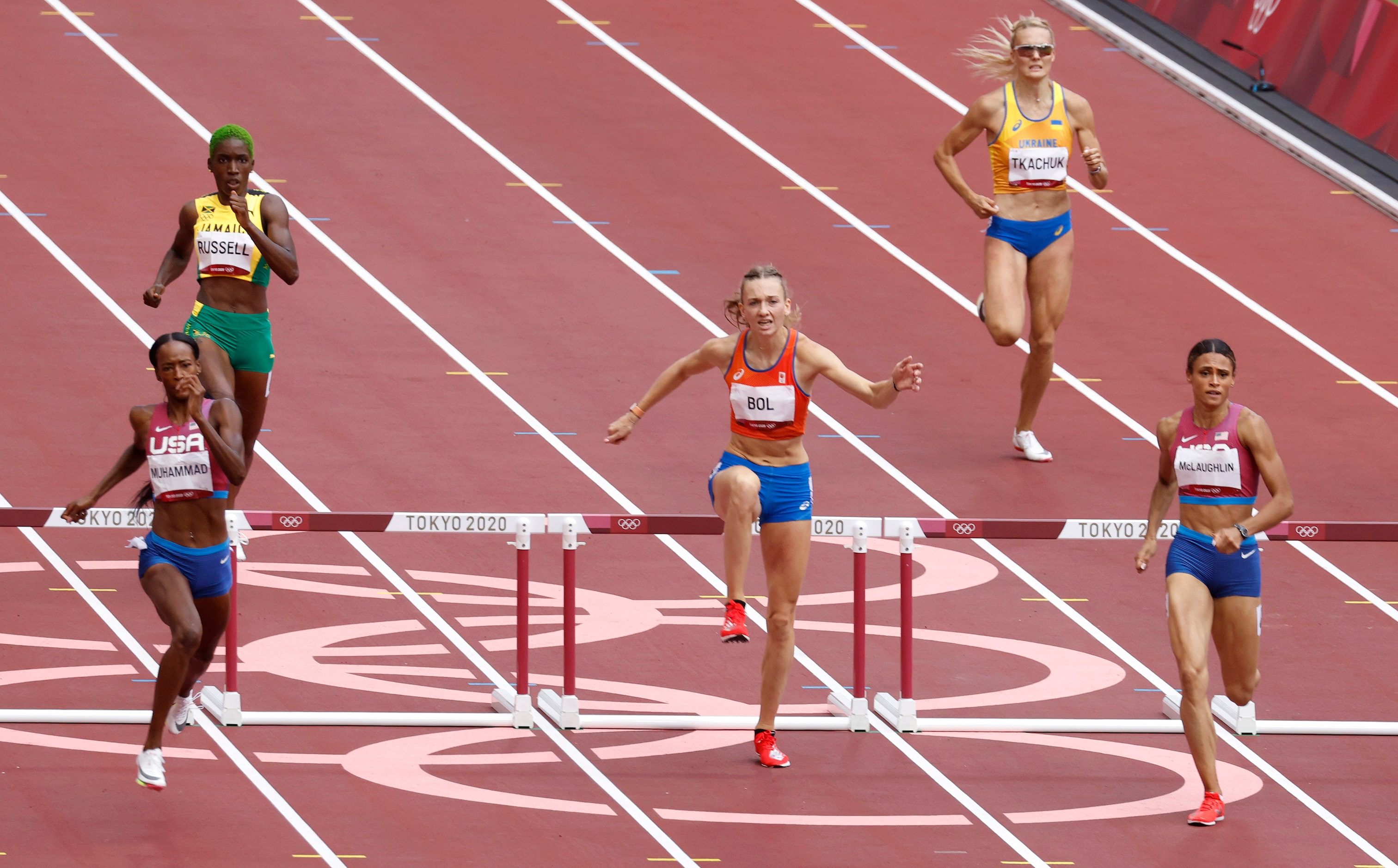 USA’s Dalilah Muhammad, Netherland’s Femke Bol, and USA’s Sydney McLaughlin clear the last...